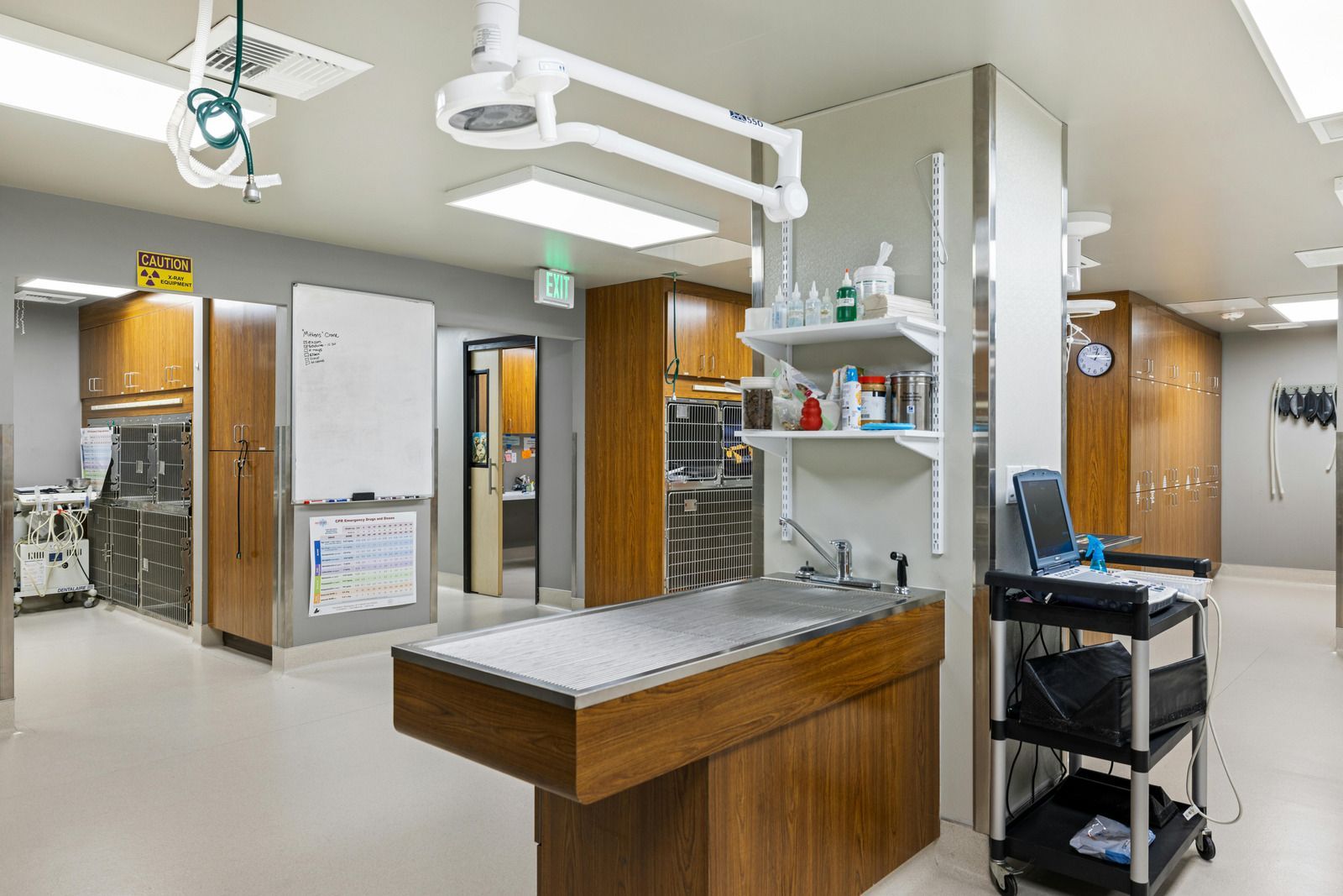Close-up of freshly poured, dark gray liquid concrete on a rough surface, forming a smooth layer.