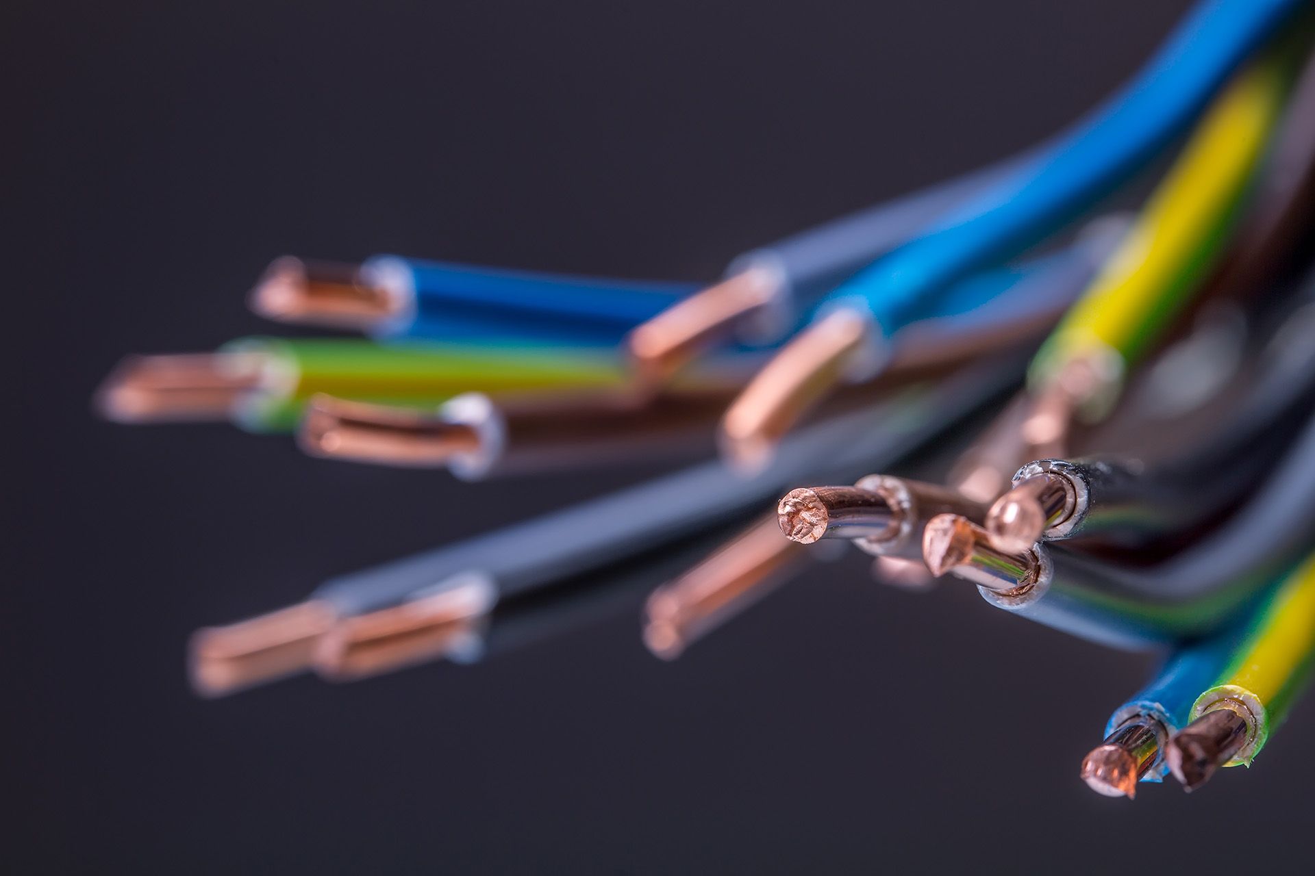 A bunch of electrical wires of different colors are laying on a table.