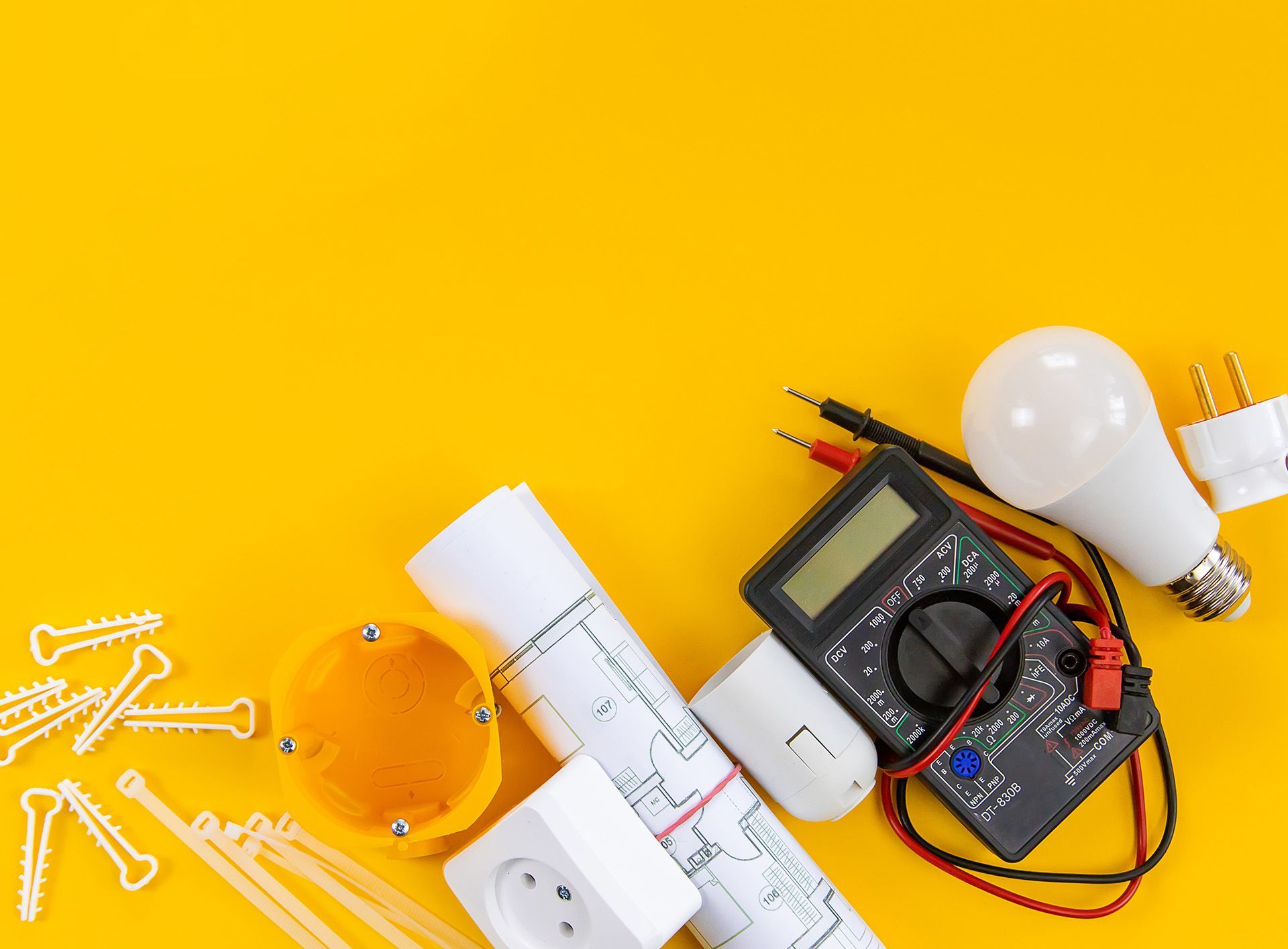 A bunch of electric tools on a yellow background.