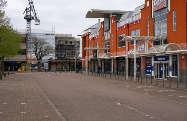 Empty Road Along Shopping Centers