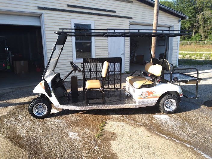 A golf cart is parked in front of a garage