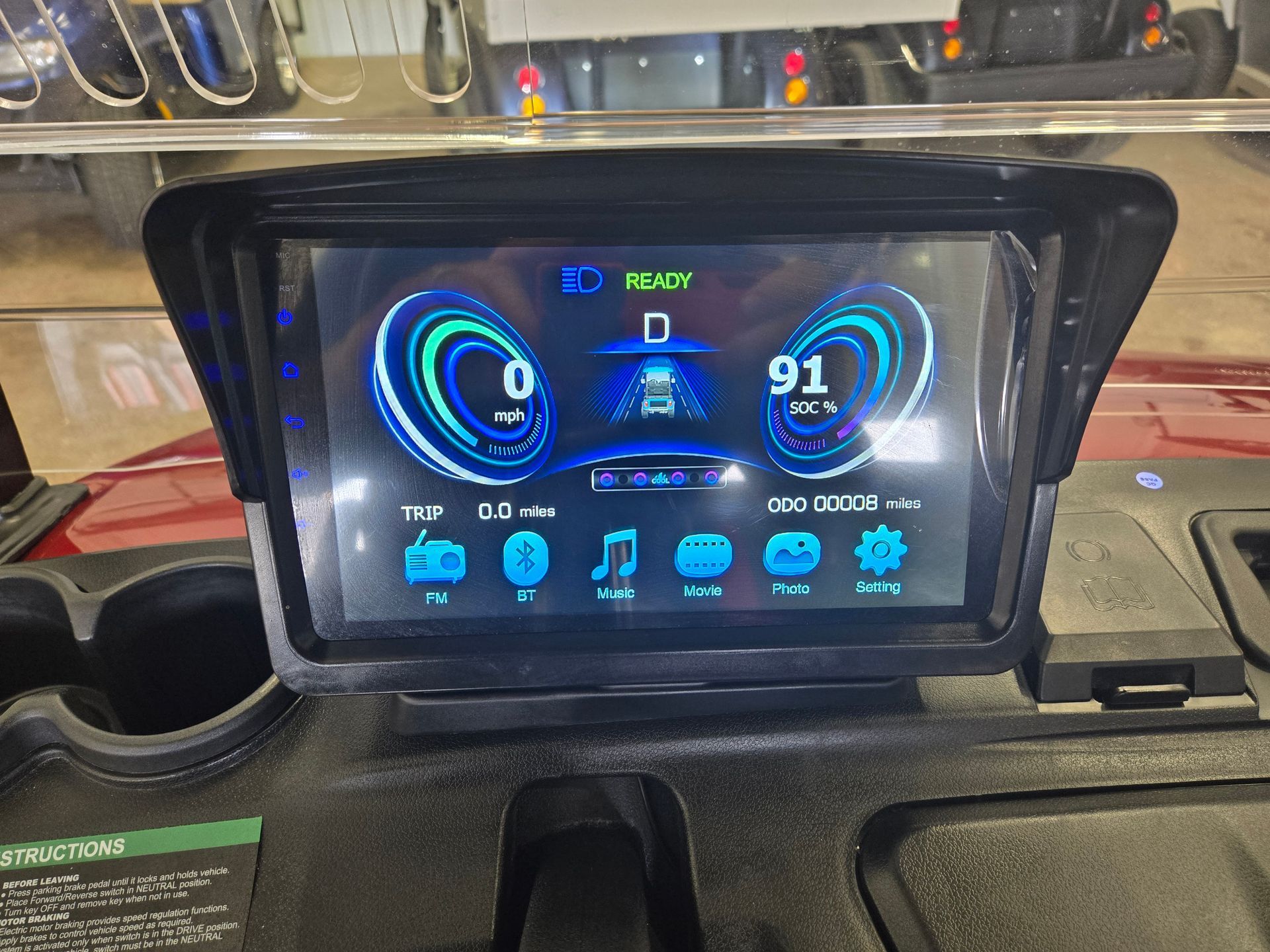 The dashboard of a golf cart with a touchscreen display.