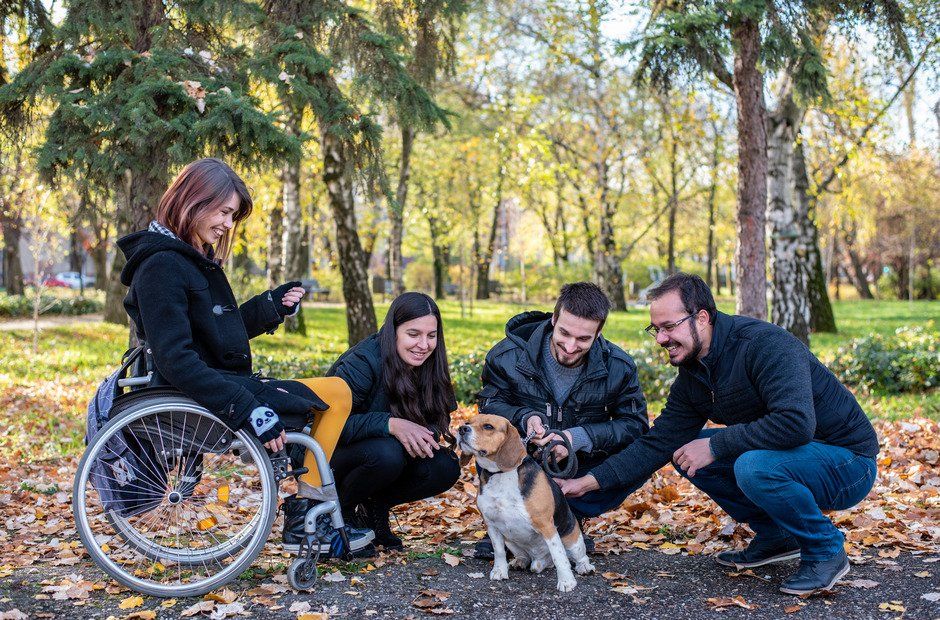 woman in wheelchair with friend and dog