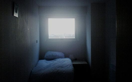 Hands hold prison bars