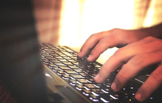 Person typing on a keyboard