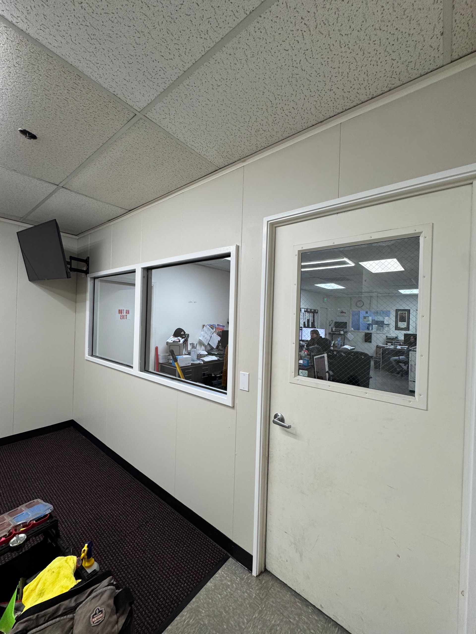 A room with a door and a lot of windows.
