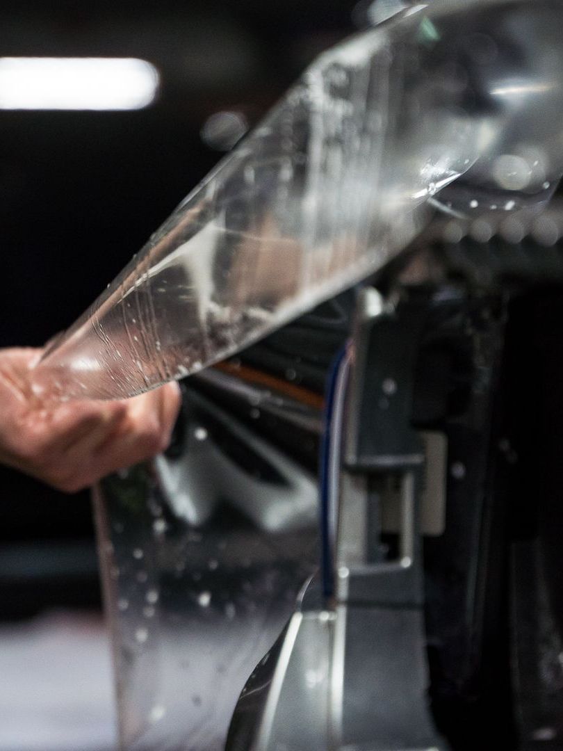 A close up of a person holding a piece of plastic