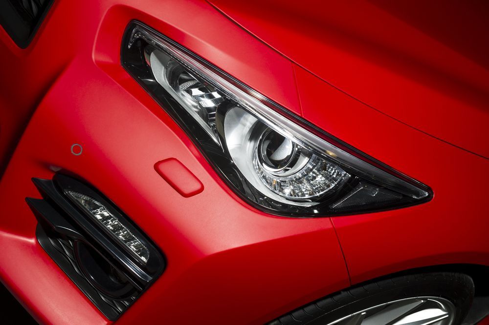 A close up of a red car 's headlight