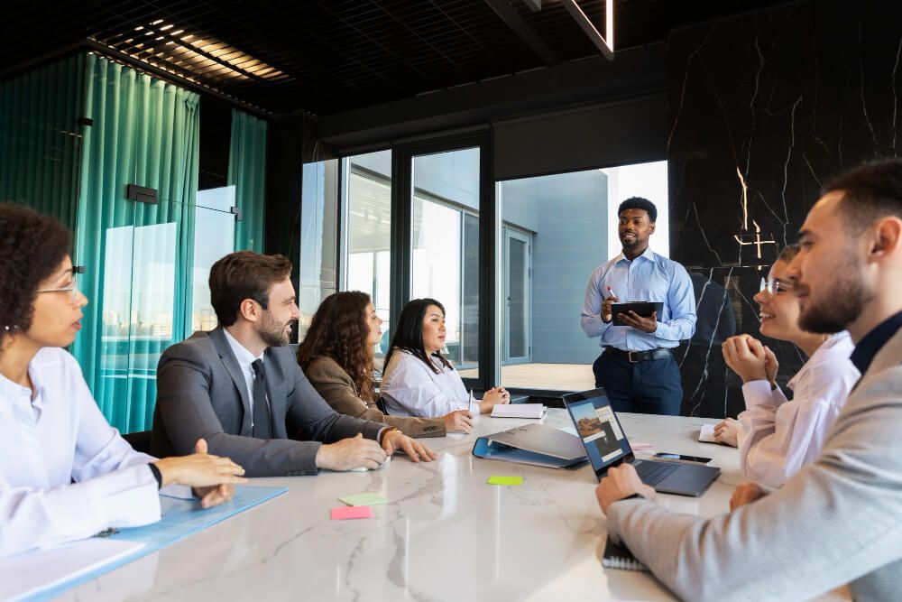 Business team meeting discussing APP 2025 changes in a modern office