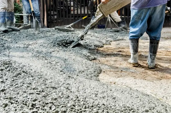 Workers pouring concrete on a construction site.