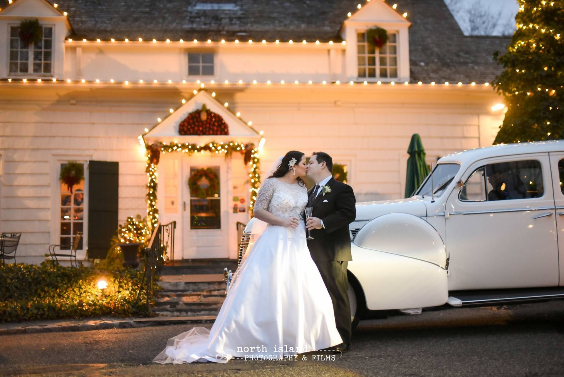 A bride and groom are sitting in a white car.