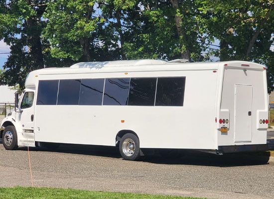 A large white bus is parked on the side of the road.