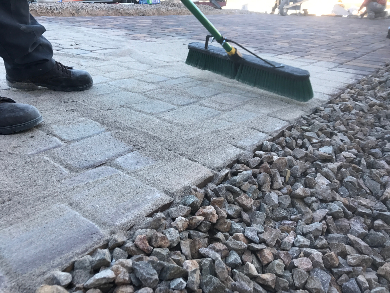 sweeping a paver walkway