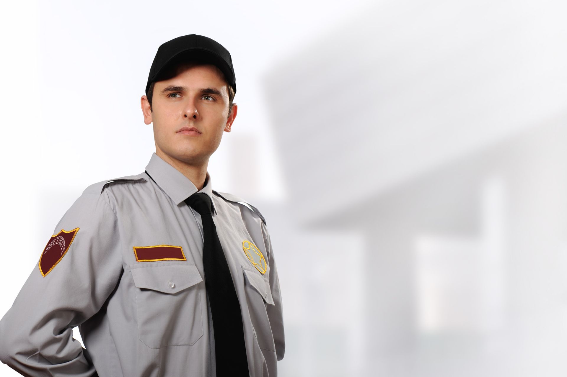 A security guard is standing in front of a white building
