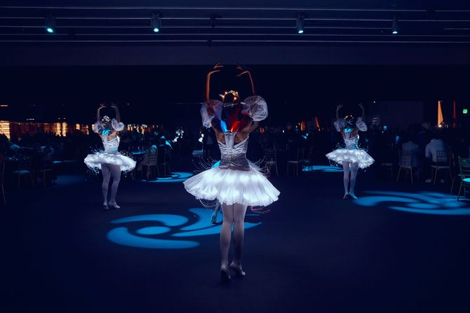 a group of women are dancing in glow in the dark costumes .
