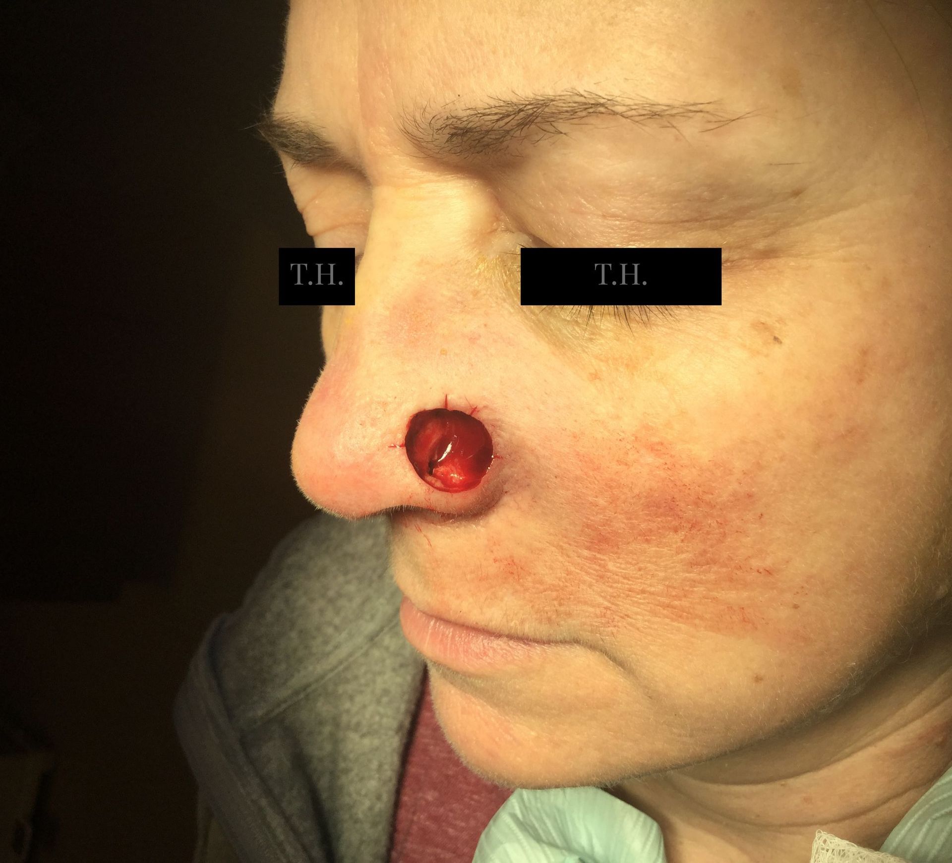 A close up of a woman 's face with t.h. written on her eyes