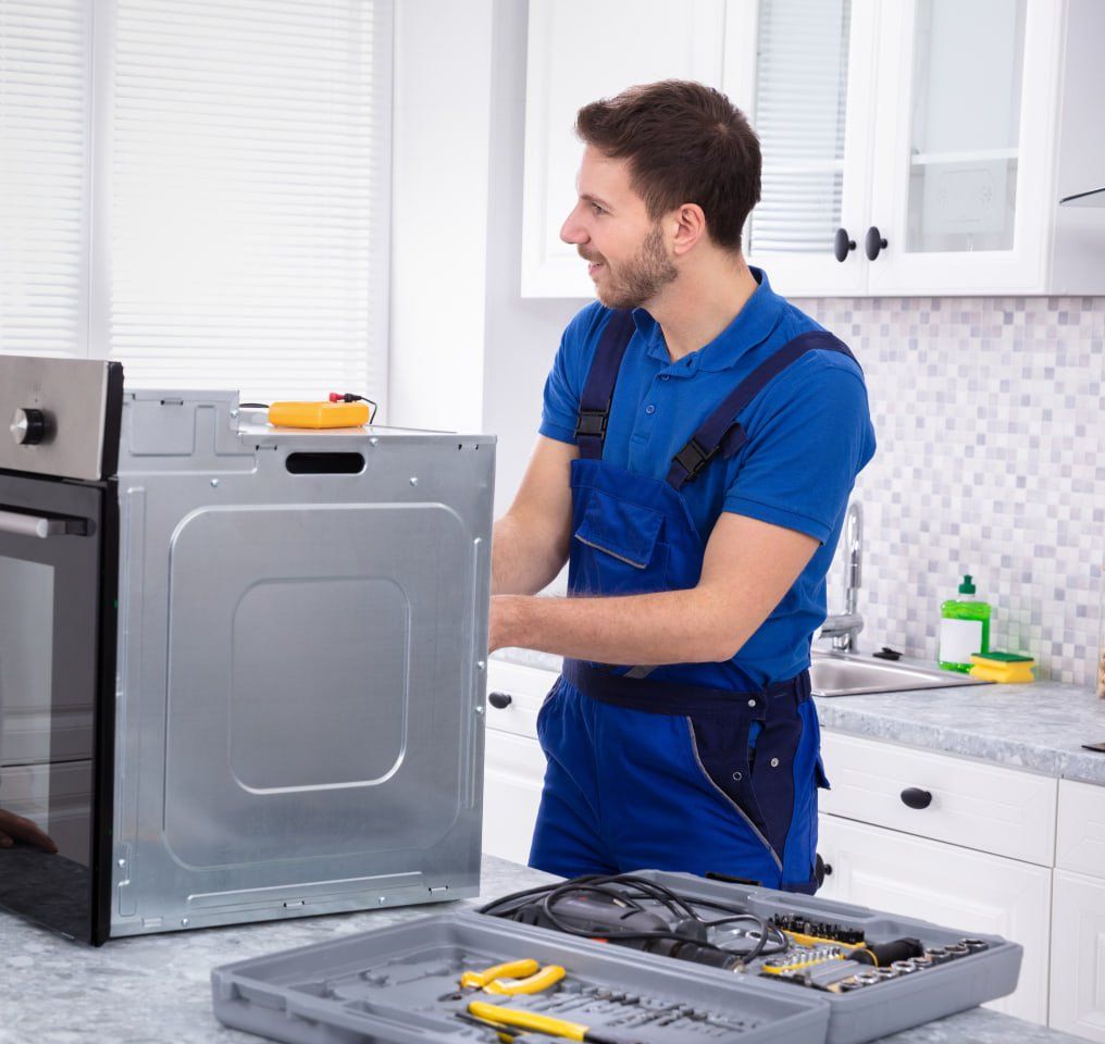 Man repair appliances  in the kitchen