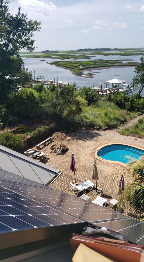 A view of a swimming pool from the roof of a house.