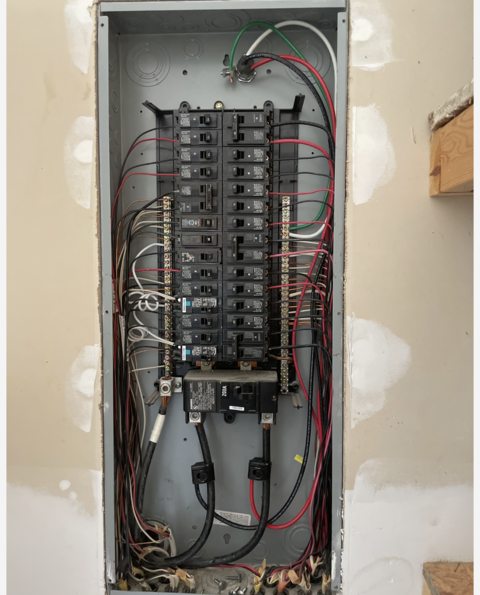 An electrical box with a lot of wires coming out of it