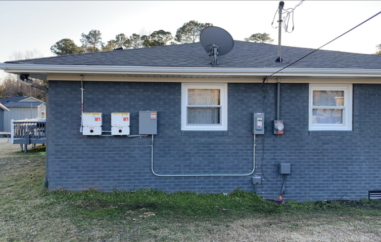 A brick house with a satellite dish on top of it