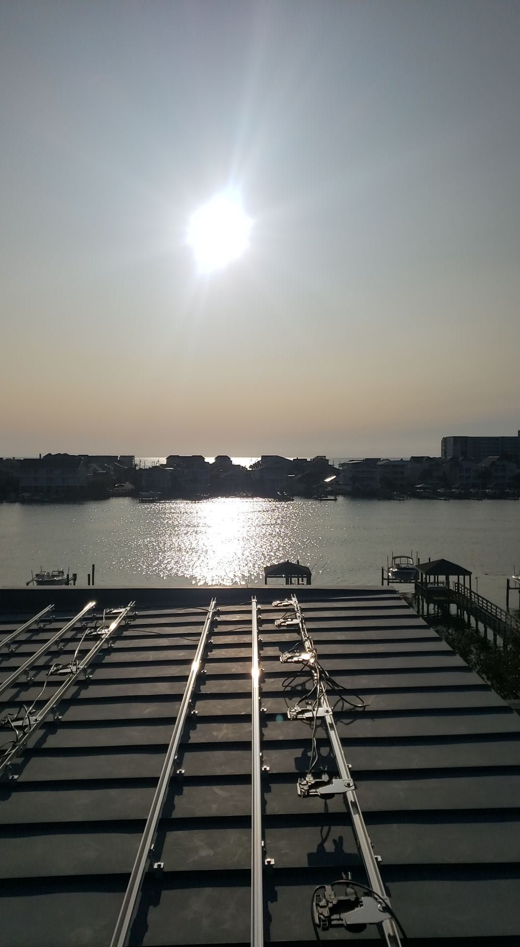 The sun is shining brightly over a body of water.