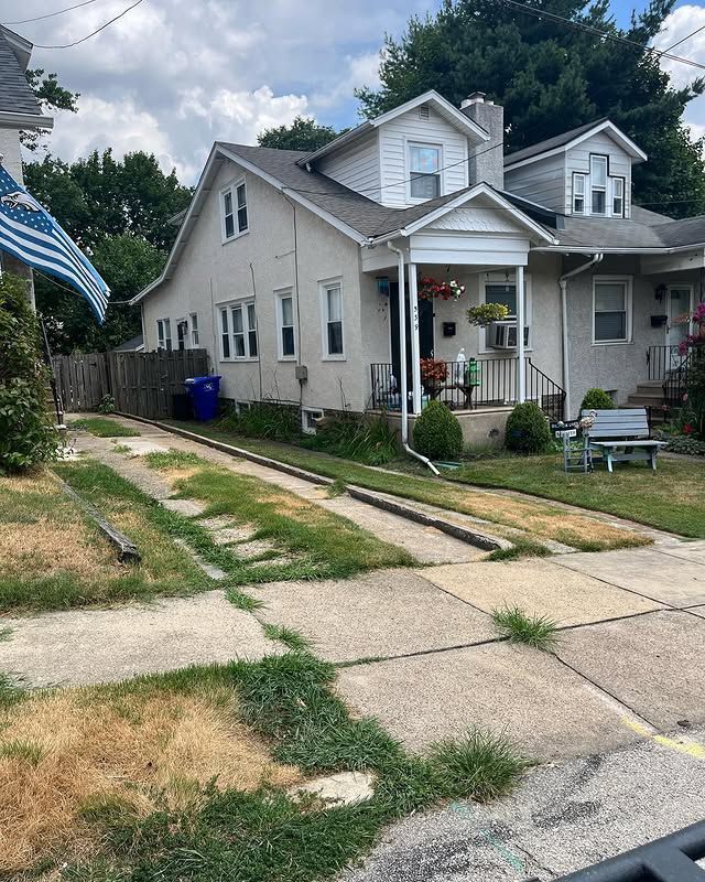 A white house with a blue and white flag on the side of it