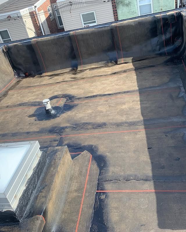 A roof with a skylight and a red line on it.