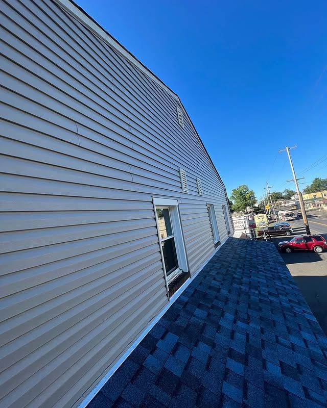 The side of a building with a blue roof and siding.
