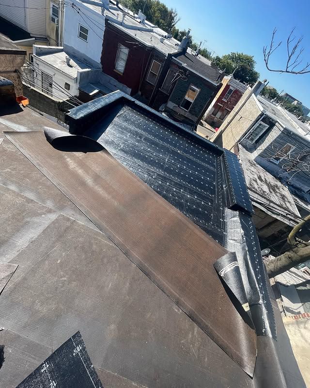 A roof with a roofing material on it is being installed on a building.