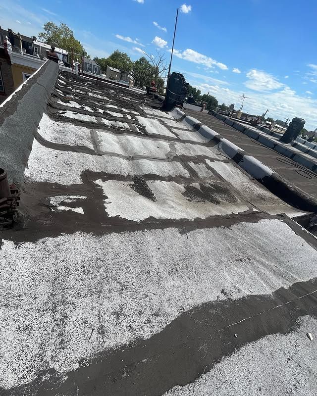 A close up of a roof with a blue sky in the background