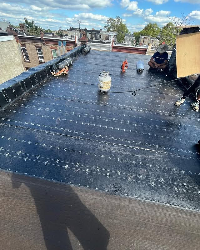A man is sitting on the roof of a building.