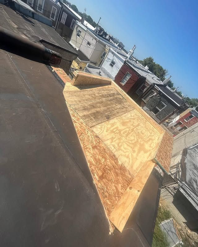 A piece of plywood is sitting on top of a roof.