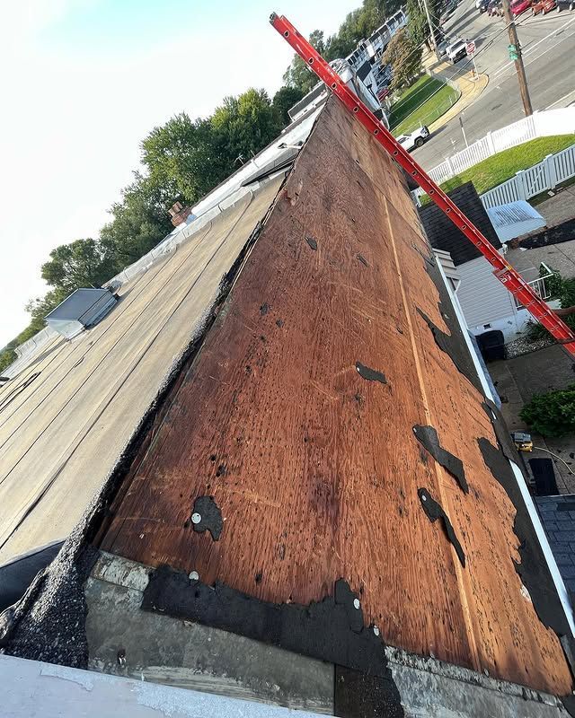 A roof with a red ruler on top of it.