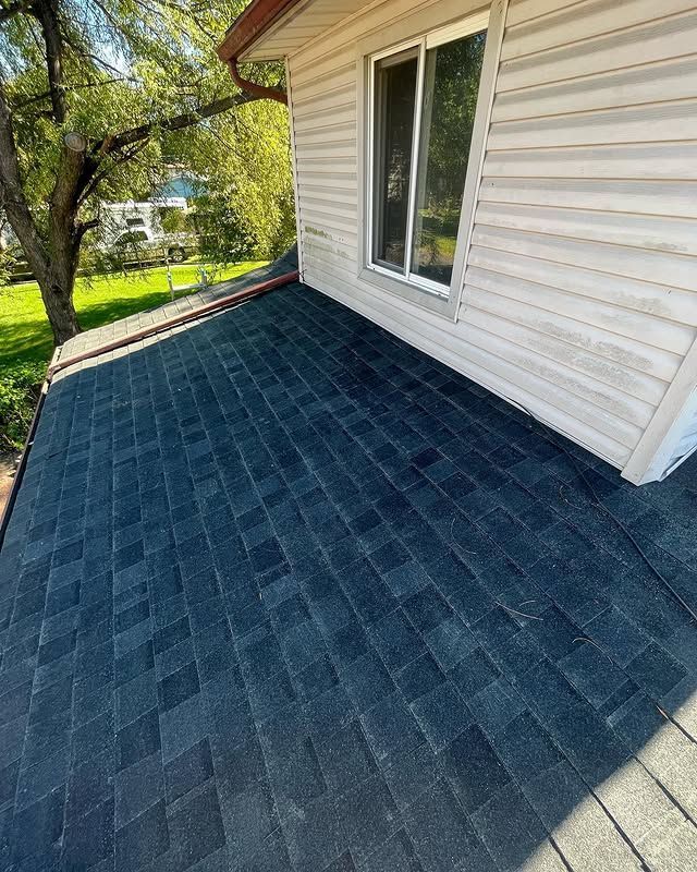 A house with a black roof and a window.