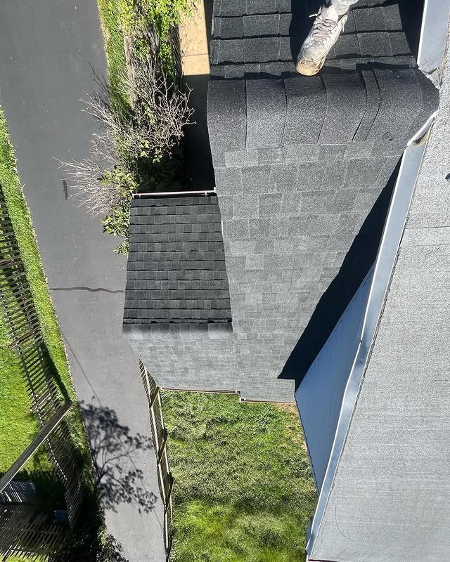 An aerial view of a house with a black roof