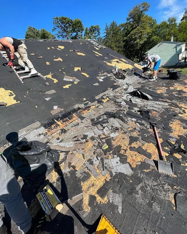 A group of people are working on a roof.