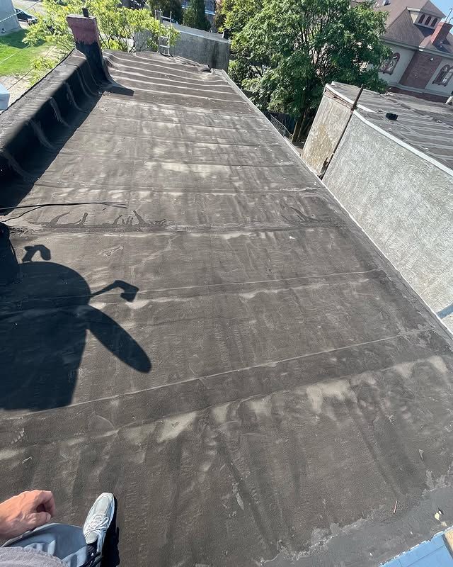 A person is sitting on the roof of a building.
