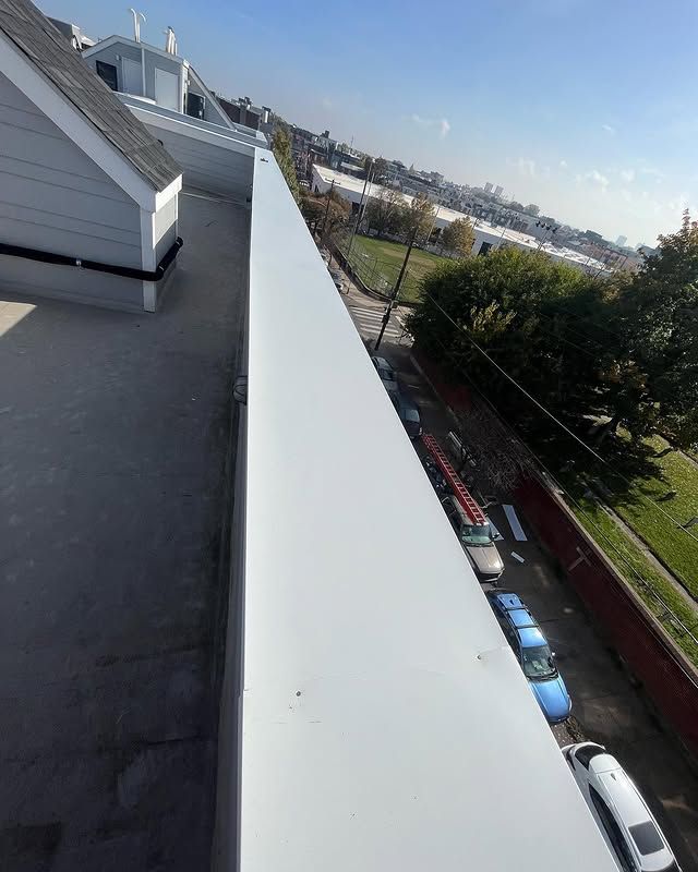 A row of cars are parked on the side of the road