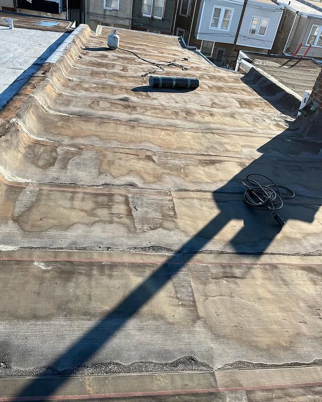 A close up of a roof with a shadow on it.
