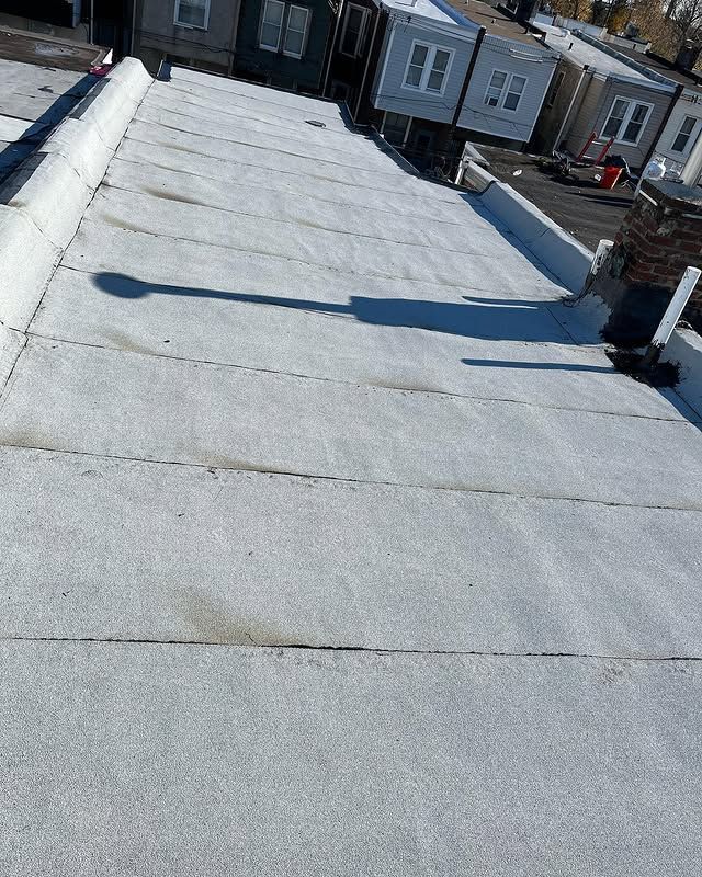 A white roof with a chimney on top of it.