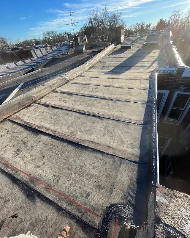 A close up of a roof with a drain on it.