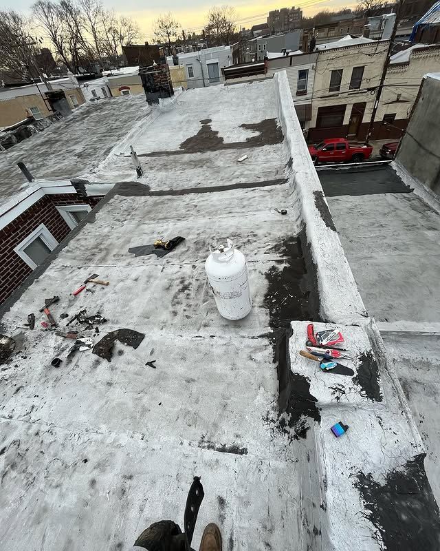 A person is standing on the roof of a building.