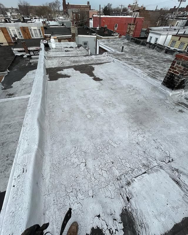 A person is standing on the roof of a building.