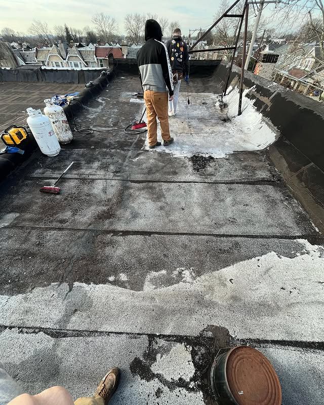 A group of people are standing on top of a roof.