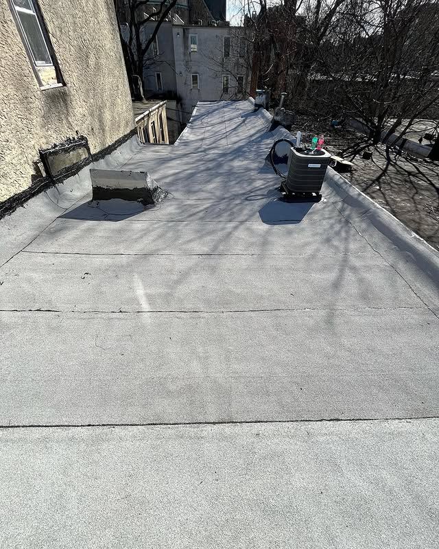 There is a vacuum cleaner on the roof of a building.