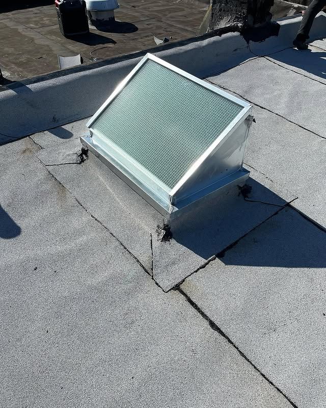 A skylight is sitting on top of a roof.