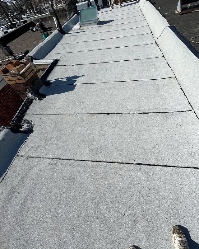 A person is standing on the roof of a building.