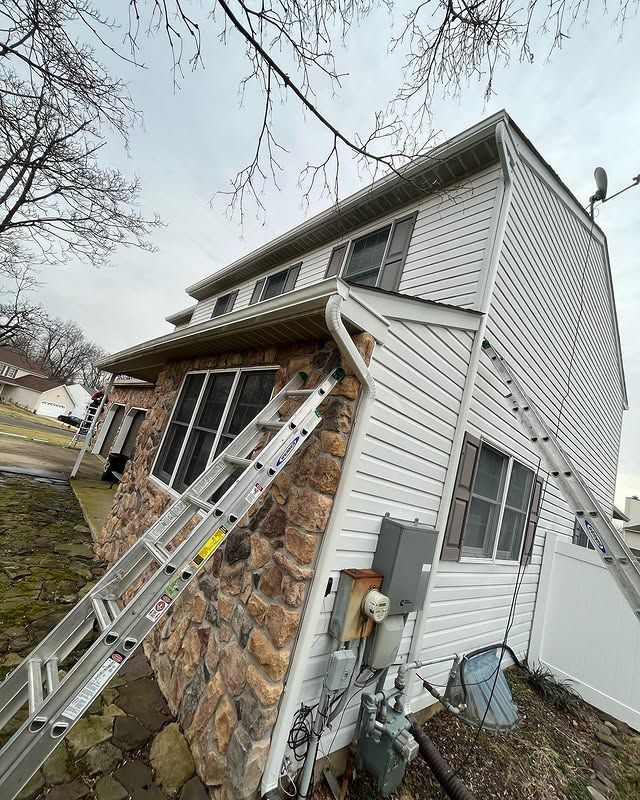 A ladder is leaning against the side of a house.
