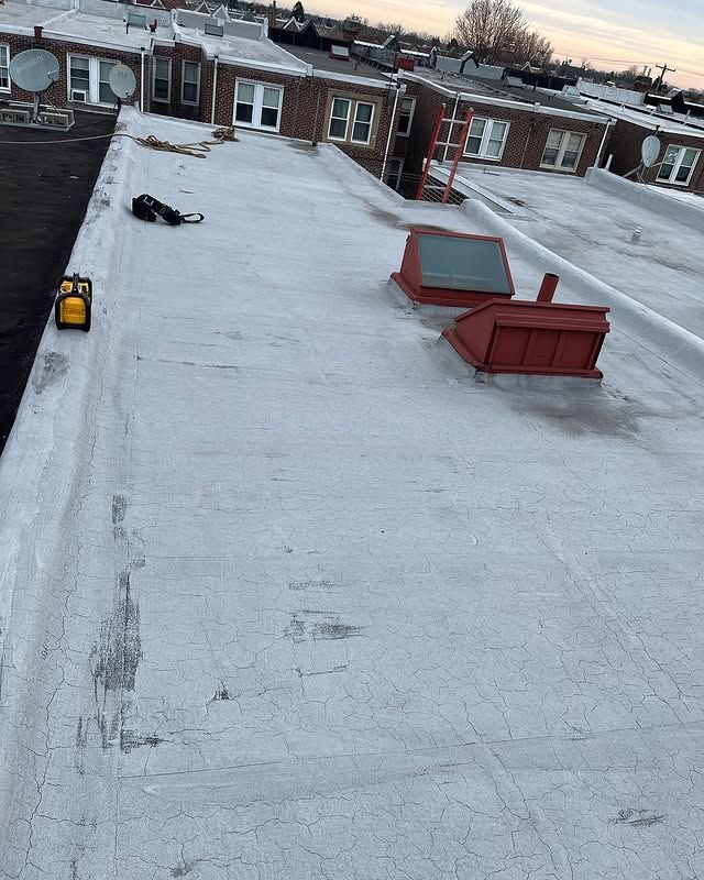 A white roof with a red chimney on top of it.
