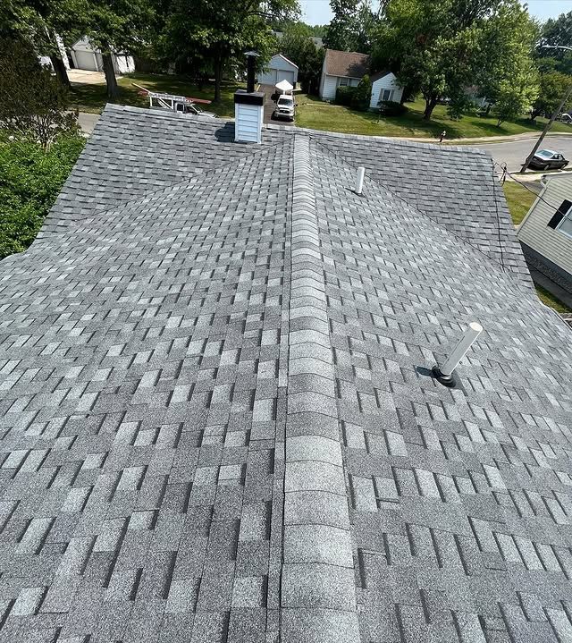 A close up of a roof with a chimney on top of it.